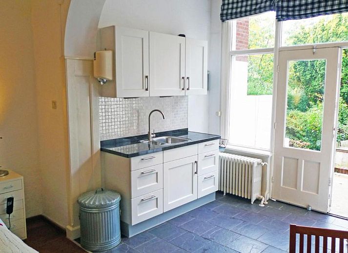 Keuken met uitzicht op de tuin bij Bed & Breakfast Walenburg in Rotterdam, Zuid-Holland.