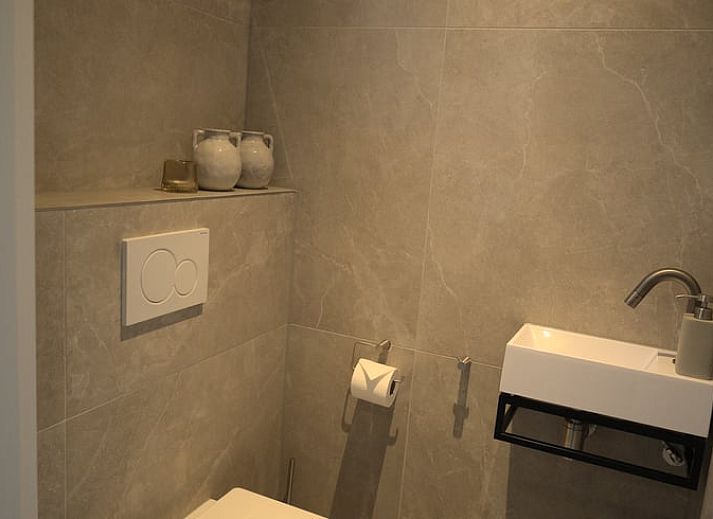 Hanging flower baskets and colorful flowers at Holiday home in Oldenzaal, a rustic stay in Twente.