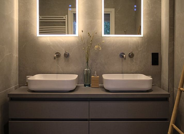 Hanging flower baskets and colorful flowers at Holiday home in Oldenzaal, a rustic stay in Twente.