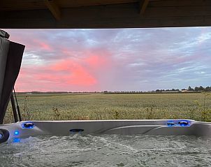 Jacuzzi met uitzicht op de zonsondergang bij Vakantiehuisje in Kraggenburg, Flevoland.
