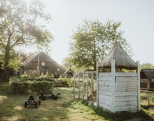 Speeltuin met houten speeltoestellen bij Huisje in Oosterwolde, Veluwe, Gelderland.