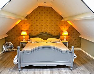 Sfeervolle slaapkamer in Vakantiehuisje in Uddel, Veluwe, met knusse ambiance.