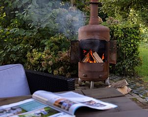 Buitenruimte Vakantiehuisje in Heerde, Veluwe, met gezellige zithoek en natuur in Gelderland.