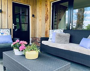 Comfortabele zithoek op de veranda van Huisje in Overdinkel, een uitnodigende B&B in het hart van Overijssel.