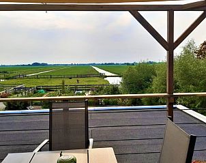 Uitzicht vanaf het terras van Huisje in Bodegraven, geniet van de uitgestrekte natuur in het Groene Hart, Zuid-Holland.